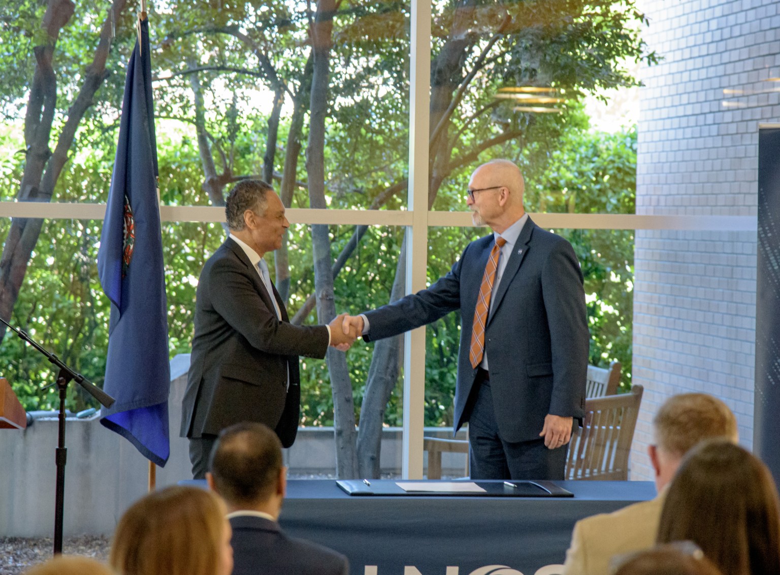 John Koelling of NASA Langley shakes hands with Mark Johnson of UNOS after signing the agreement in Richmond.