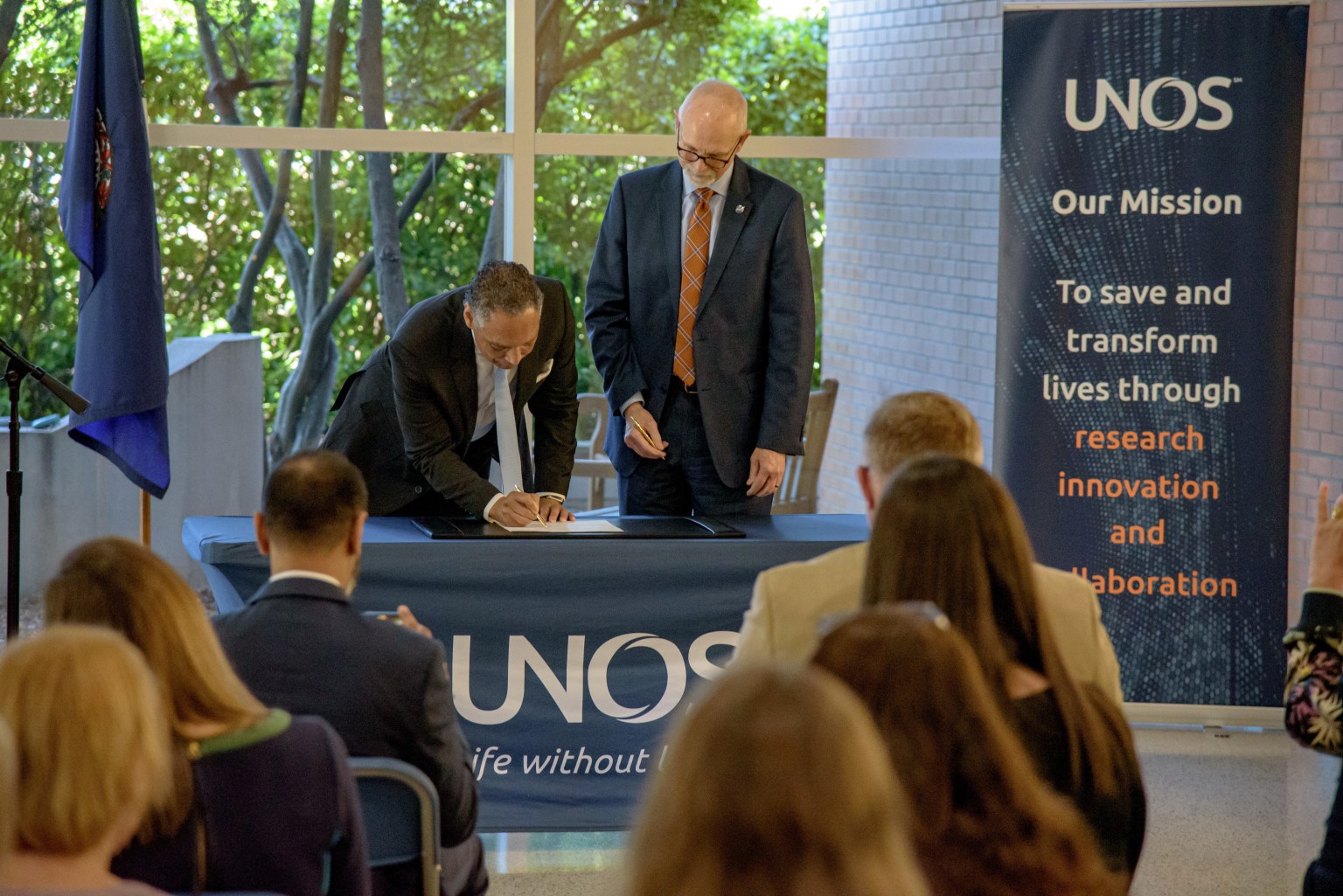 Mark Johnson, UNOS interim CEO, signs the Space Act Agreement with John Koelling of NASA Langley Research Center.